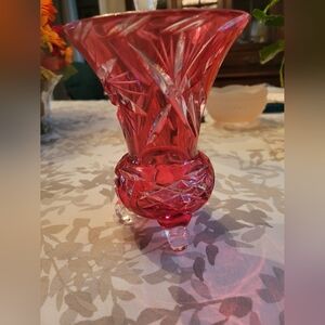 1940's Cranberry cut crystal vase on tripod feet. Chip under top edge at cutting